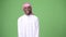 Young African man wearing traditional Muslim clothes against green background