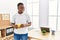 Young african man working drinking a coffee at business office