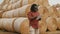 Young african man,working on tablet in front of the hay roll stack. Smart farming concept