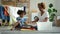 Young african mother and american daughter fold clean dry laundry in living room together Spbd