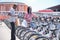 Young african tourists renting a bike at a bicycle rental service machine.