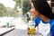 Young african woman with braided hair sipping juice at cafe