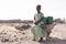 Young African Woman Gathering Fresh Water in a rural village