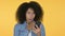 Young African Woman Loss on Smartphone, Yellow Background