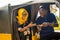 young african woman sitting in the back seat of an auto rickshaw taxi paying the driver