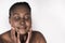 Young African woman touching her face against a white background