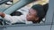 Young afro american girl driver stressed african ethnic woman sitting in car in traffic jam screaming swears angry with