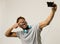 Young afro american man smiling happy taking selfie self portrait picture with mobile phone