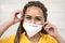 Young Afro woman with braids wearing face medical mask portrait - African girl using facemask for preventing and stop corona virus