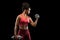Young afro woman pumping iron over black background