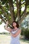 Young aging woman in reflection with a tree for revitalization