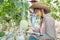 Young agricultural enginner studying new sort of melon growing