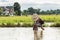 Young agriculturist fishing in swamp