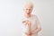 Young albino blond man wearing casual t-shirt standing over isolated white background looking at the camera blowing a kiss with