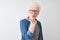 Young albino blond man wearing denim shirt and glasses over isolated white background looking at the camera blowing a kiss with