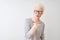 Young albino blond man wearing striped t-shirt and glasses over isolated white background looking at the camera blowing a kiss