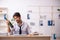 Young alcohol addicted employee sitting in the office