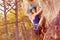 Young alpinist girl climbing on a mountain rock