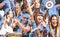 Young amateur football fan supporters cheering with flags watching local soccer cup match at stadium - Friends people group