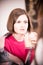 Young amazed brunette woman sitting in the cafe and drinking coffee.