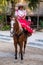 Young amazon riding a purebred horse at the XCaret park in Mexico
