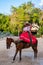 Young amazon riding a purebred horse at the XCaret park in Mexico