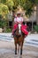 Young amazon riding a purebred horse at the XCaret park in Mexico