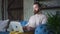 Young american businessman talking during video conference and using laptop on couch at home spbd.