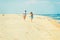 Young American Couple running, relaxing on the beach in New Jersey, USA