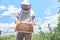 Young Apiarist Holding Hive Frame