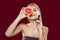 Young appealing model holding half of grapefruit near her face