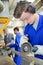 Young apprentice using a metal cutter