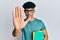 Young arab handsome man wearing glasses and holding books with open hand doing stop sign with serious and confident expression,