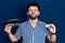 Young arab man with beard holding glasses and contact lenses looking at the camera blowing a kiss being lovely and sexy