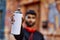 Young arab man relaxed holding graffiti spray at street