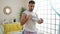 Young arab man standing tired using towel sweating at home