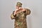 Young arab man wearing camouflage army uniform smiling in love doing heart symbol shape with hands