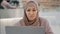 Young arab sorrowful woman in hijab reading message on laptop gets bad news denied bank loan job dismissal bankruptcy