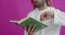 Young Arabian Muslim man in traditional clothes praying reading Quran