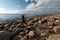 Young archaeologist on a boulder beach looking for exotic rocks on a coastline of a Baltic Sea