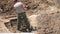 Young archeologist works on an archaeological site at morning sun rays at summer heat