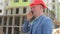 Young architect talking on the phone at the construction site