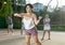 Young Argentinian woman playing frontenis at open-air fronton in summer