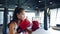 Young Asia lady kickboxing exercise workout punch doing shadow female fighter practice boxing in gym fitness class. Sportswoman