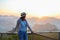 young asia woman feeling happy wearing hat resting on tropical mountain at Doi Ta Pang (khao thalu) travel in thailand