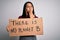 Young asian activist girl asking for environment holding banner with planet message cover mouth with hand shocked with shame for