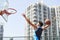 Young asian adult man dunking basketball