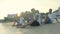 Young asian adult men sitting on beach relaxing singing playing guitar