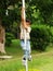 Young Asian boy climbing pole