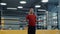 Young asian boy with a focused face quickly jumps rope near the ring warming up before boxing. Preparation for the